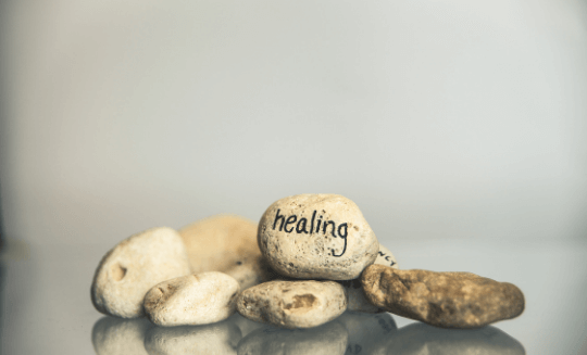assortment of rocks with the word "healing" written on one 
