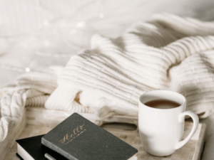 cup of coffee next to a white sweater