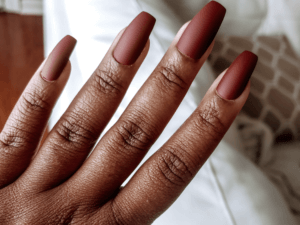 hand with red press on nails