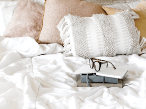 comfortable bed with pink and white pillows